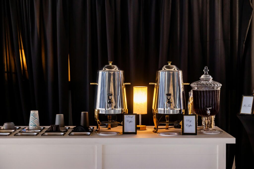 Stylish coffee station setup with polished dispensers and glassware in bulk from friends coffee bar for events.